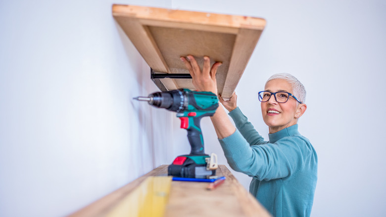 woman anchoring a shelving unit