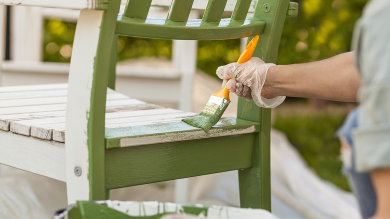 person painting chair