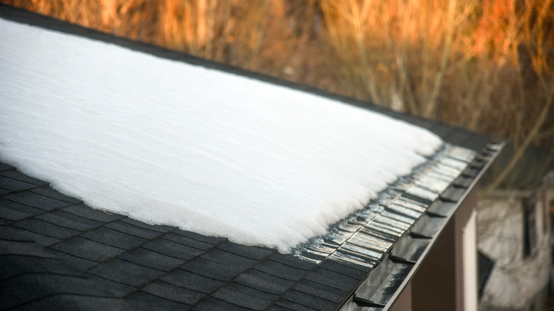 Snow melting on shingled roof