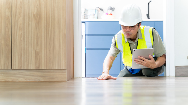 professional inspecting floor