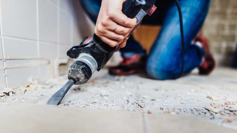 person removing tile with jackhammer