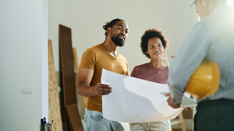 Couple looking at blueprints