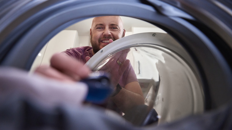 Man putting pod on laundry