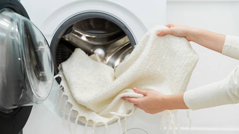 A blanket being taken out of a washing machine