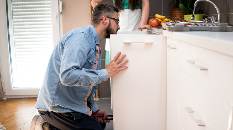 Man looking under his sink