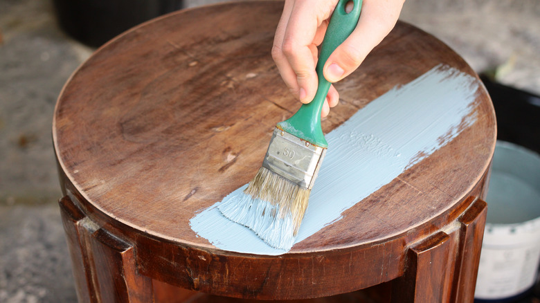 person chalk painting table