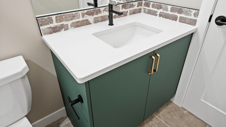 A green bathroom vanity