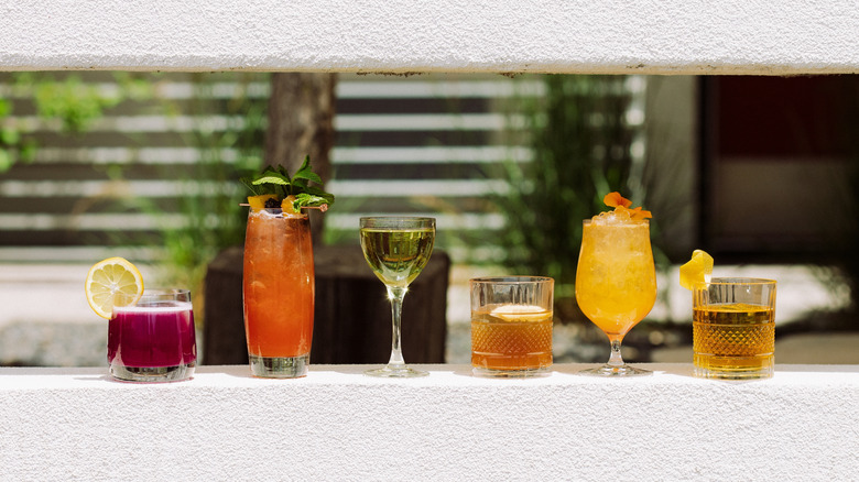 Row of colorful cocktails in outdoor bar