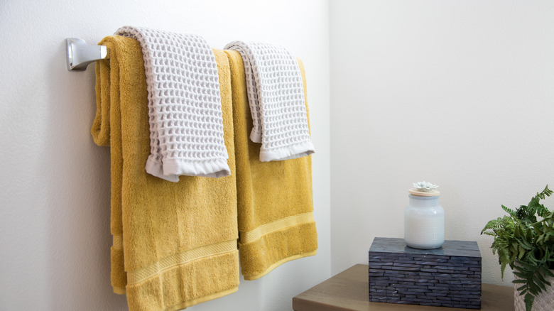 Yellow towels on rail in bathroom