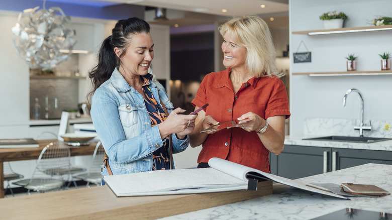 women viewing granite samples