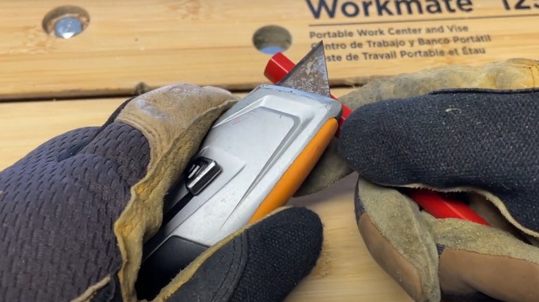 Person sharpening carpenter's pencil with knife