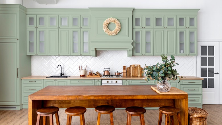 Soft green kitchen cabinets