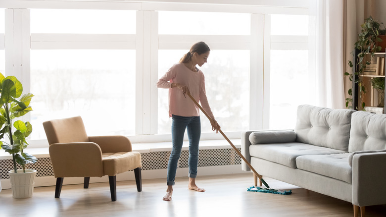 Woman mops laminate floor