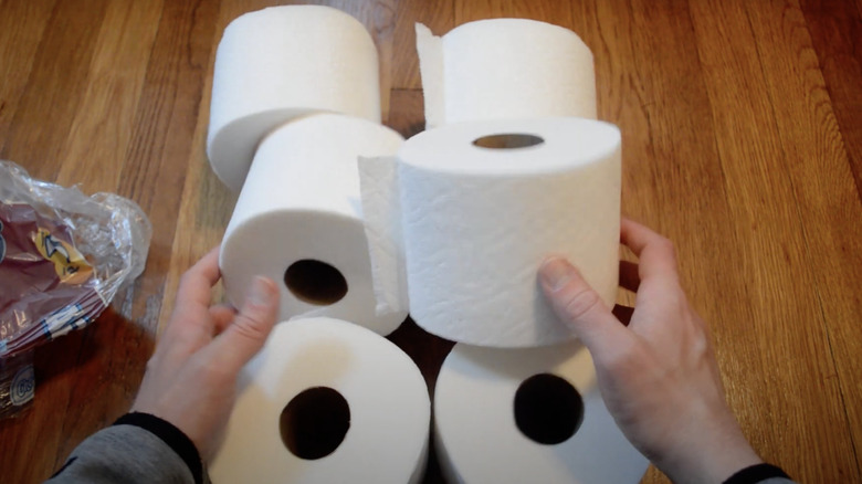 person unboxing strong toilet paper