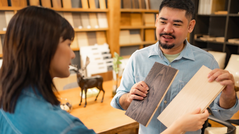 A woman looking at flooring options