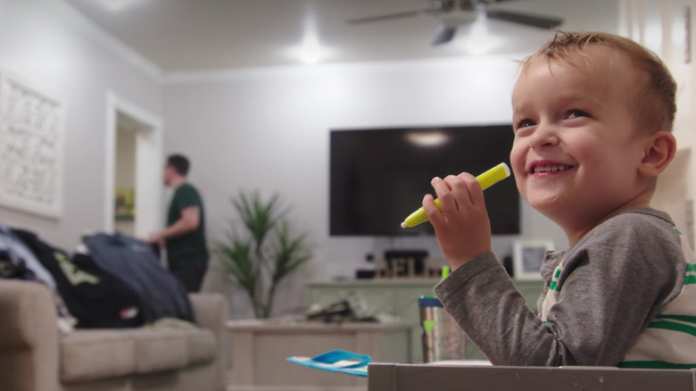 child holding highlighter in home