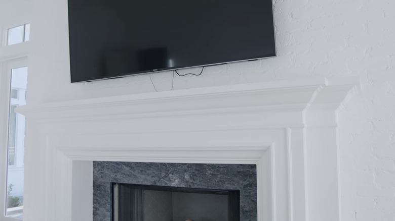 TV cables hang from a TV