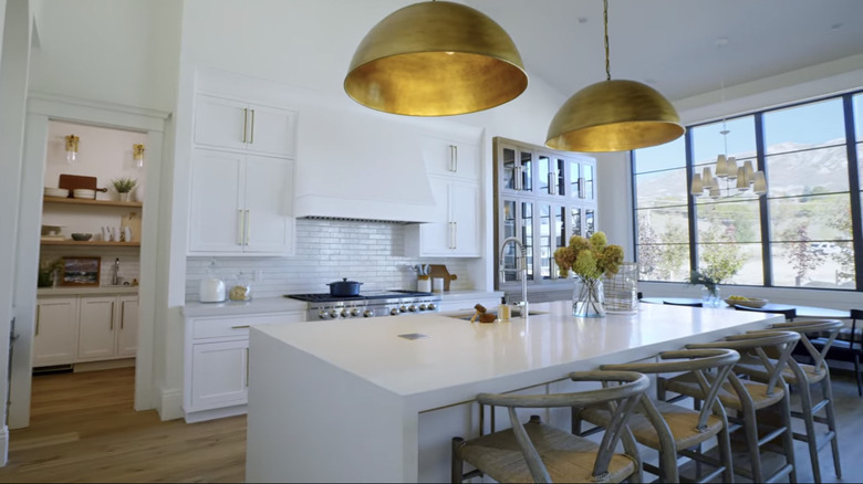 A white kitchen with gold accents