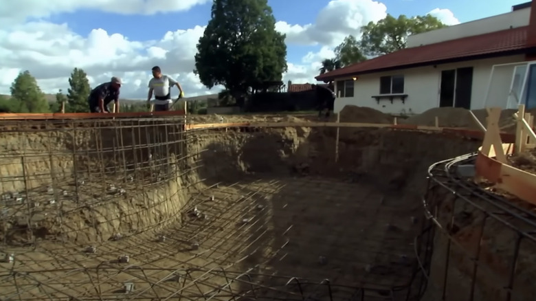 Pool under construction in backyard 