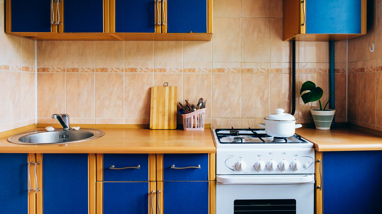 blue kitchen  with peach tiles