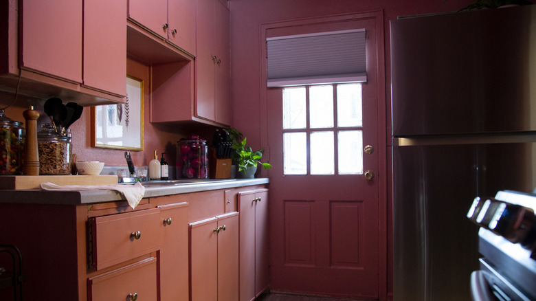 pink kitchen with cabinets