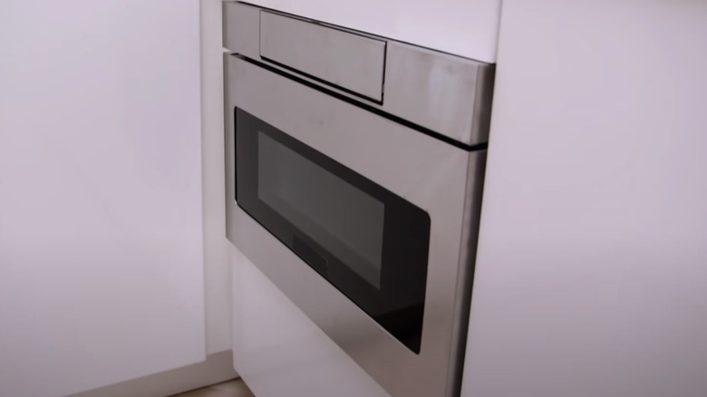 silver microwave installed into wall