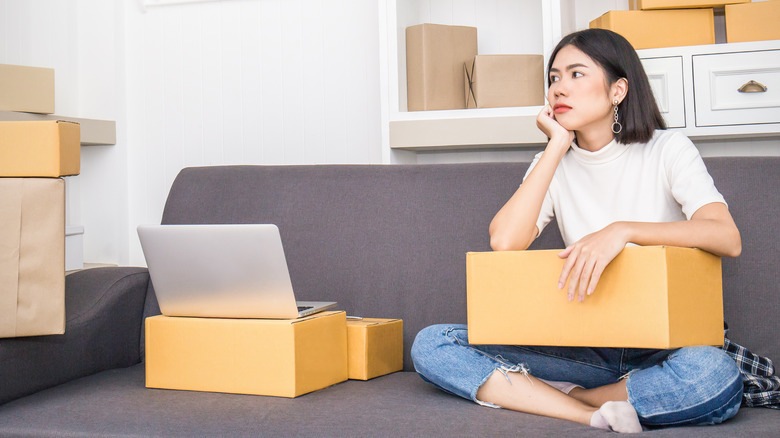 Woman sitting with boxes