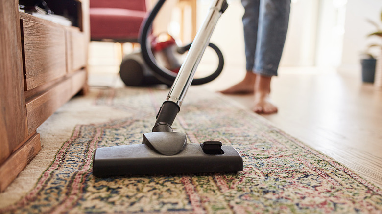 Close-up of vacuuming rug