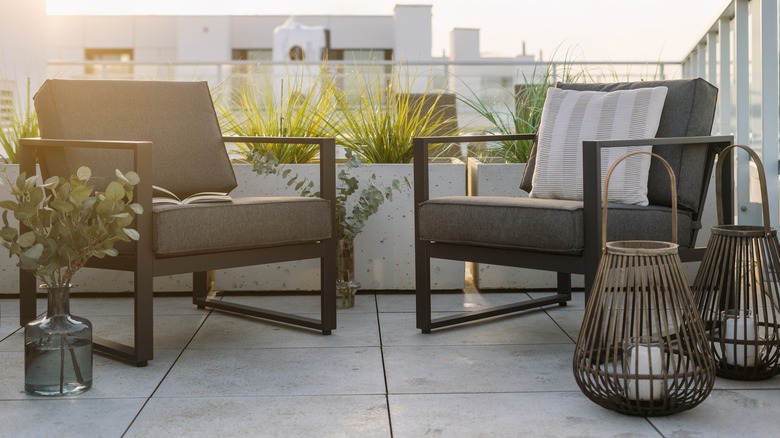 a balcony has a patio area with a table and two chairs