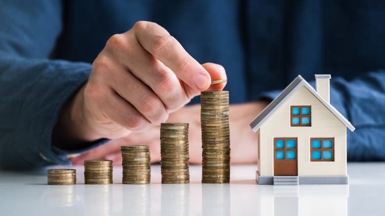 Coins stacks and miniature house