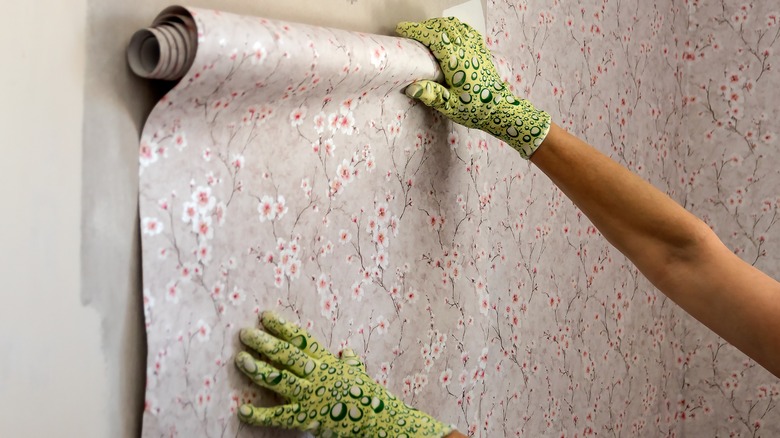 applying wall paper to wall