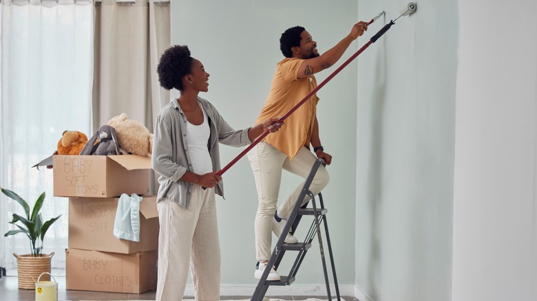 couple painting the walls