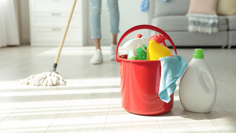 cleaning supplies with person mopping