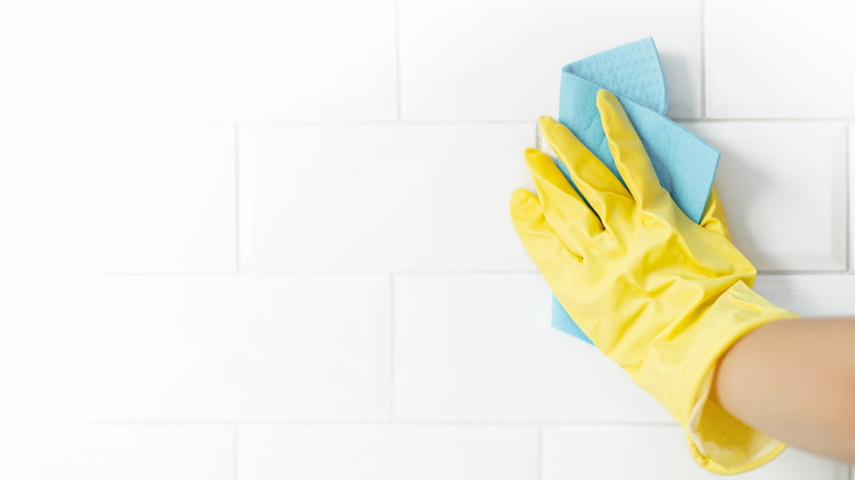 wiping down bathroom tiles