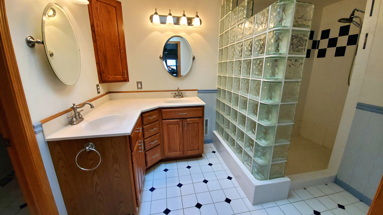 outdated bathroom with glass blocks and wooden cabinets