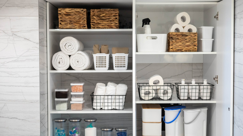 Bathroom storage shelves with baskets filled with essentials