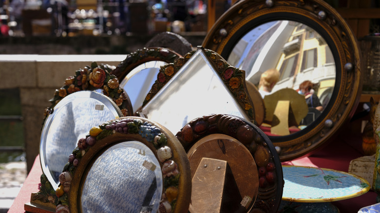 Vintage mirrors on display at a flea market