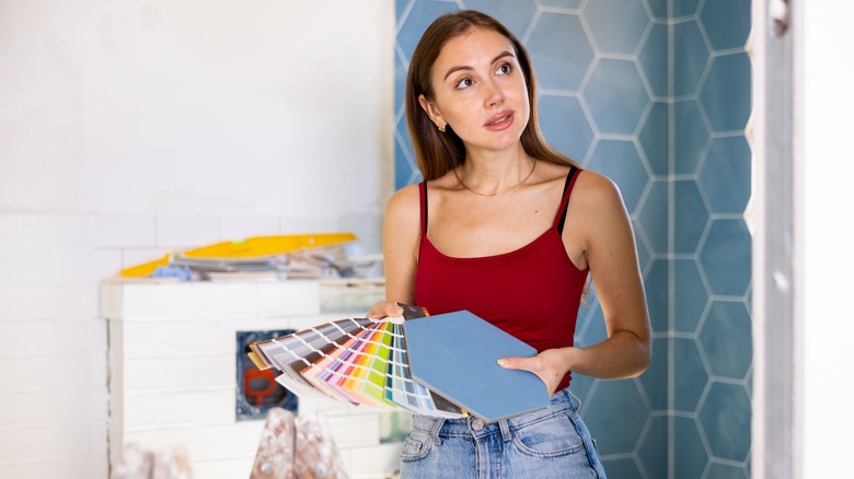 person weighing bathroom paint color