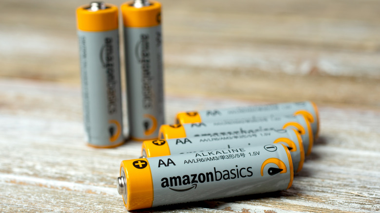 Amazon Basics AA batteries on a wooden surface