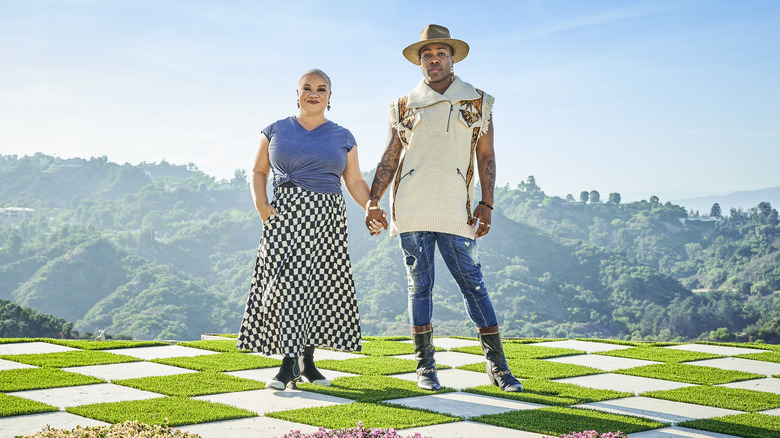 Todrick Hall and Kim Myles holding hands on mountain patio