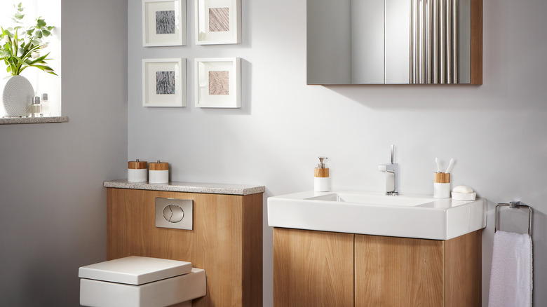 Modern bathroom with grey walls and natural wood fixtures