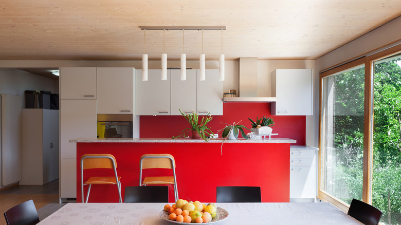 Red kitchen island with white marble countertop