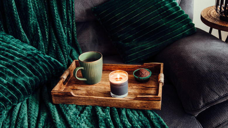 Wooden tray with coffee cup, candle