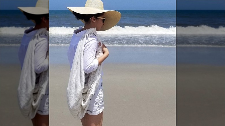 Woman wearing a beach towel bag