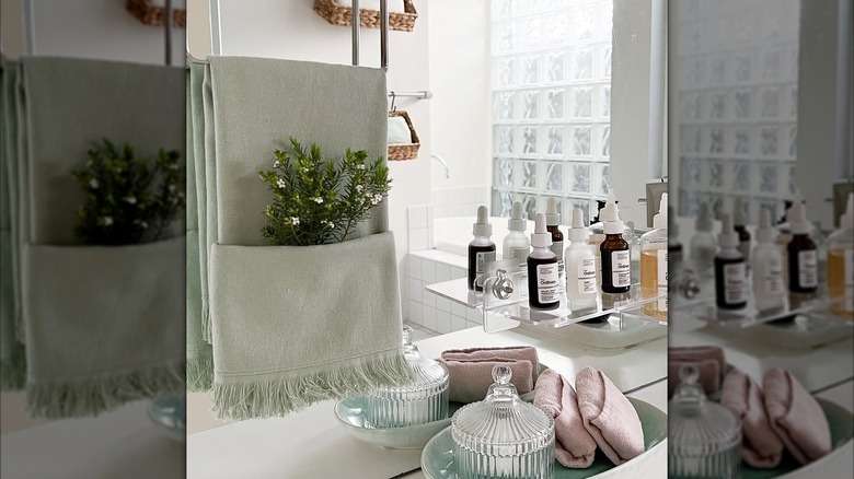 A pocket fold towel hanging in a bathroom with flowers in it