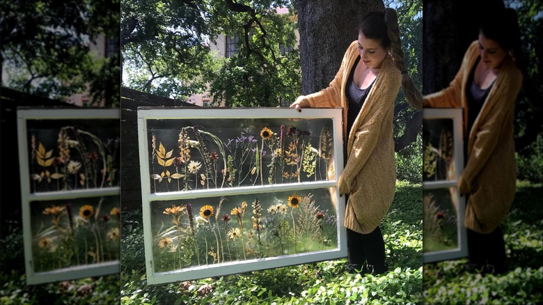 woman holding pressed flower window