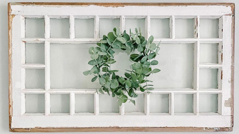 white window with eucalyptus wreath