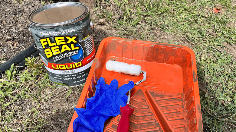 Can of Flex Seal Liquid, tray, paint roller, and protective gloves