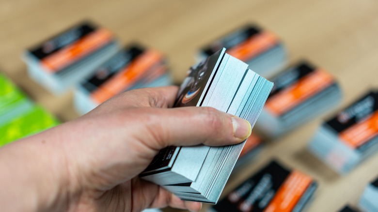 Person holding a stack of business cards