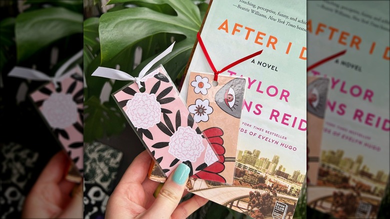 Person holding two DIY bookmarks in front of a book